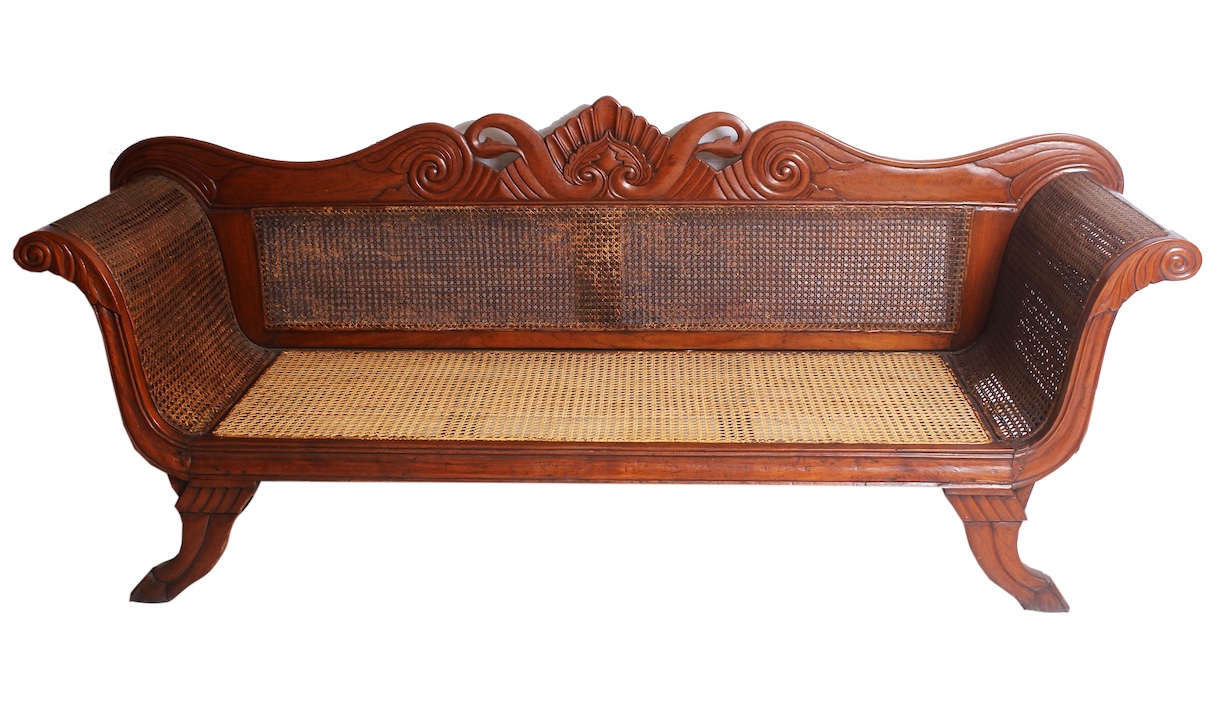 A 19th - 20th century carved teak sofa with rattan seat and back
